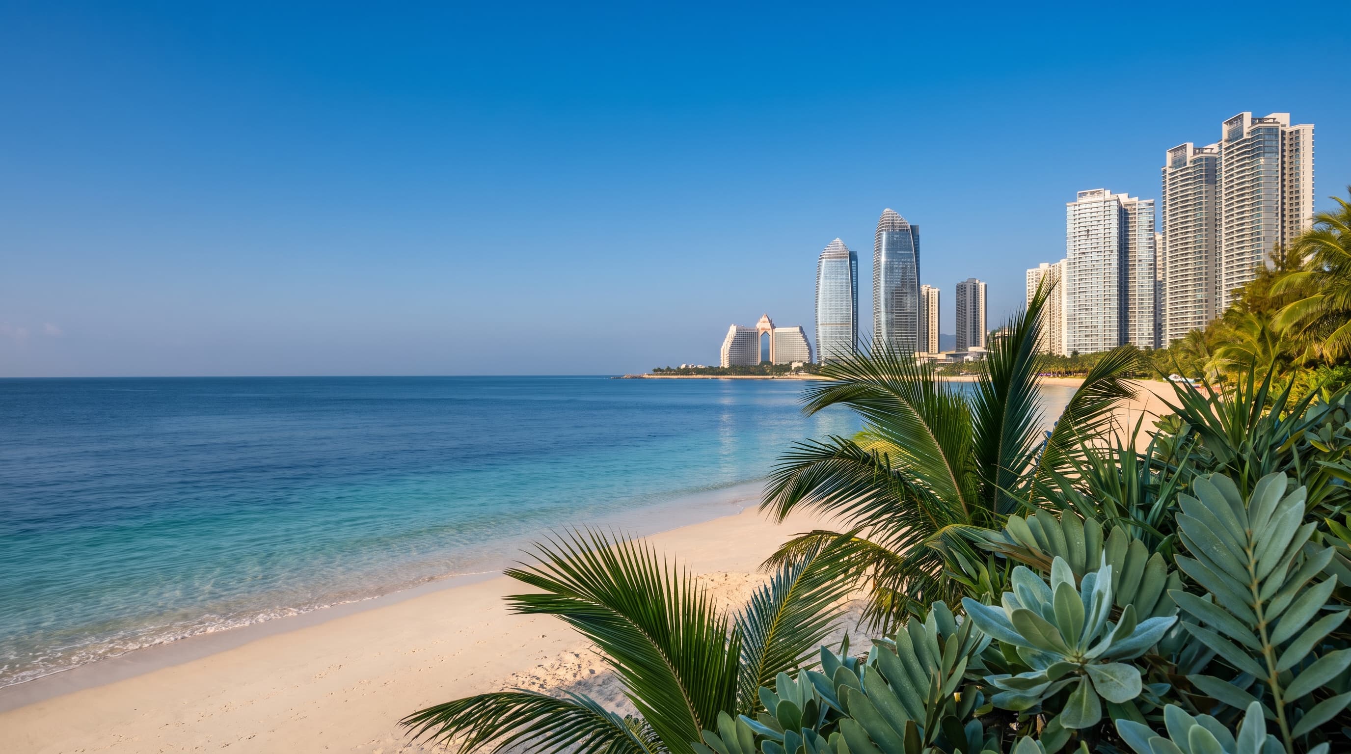 A serene Hainan coastal morning with turquoise water, clean sand, and tropical greenery.